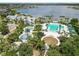 Aerial view of a community pool with splashpad, lounge chairs and verdant landscaping near lake at 11194 Spring Point Cir, Riverview, FL 33579