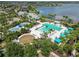 Aerial view of a resort-style community pool with cabanas, lush landscaping and splash pad at 11194 Spring Point Cir, Riverview, FL 33579