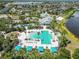Aerial view of community pool, cabanas, beach volleyball and splash pad, surrounded by lush landscaping at 11194 Spring Point Cir, Riverview, FL 33579