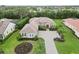 Beautiful, landscaped home with a tile roof, brick-paved driveway, and tropical landscaping at 1015 143Rd Ne St, Bradenton, FL 34212
