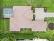 Birds eye view features a tile roof, pristine landscaping, and a screened pool at 1015 143Rd Ne St, Bradenton, FL 34212