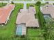 Aerial view of this home showcases a tile roof, expansive yard, and screened-in pool at 1015 143Rd Ne St, Bradenton, FL 34212