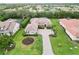 A luxurious home featuring paver driveway, lush landscaping, and a tile roof at 1015 143Rd Ne St, Bradenton, FL 34212