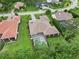 An aerial view displays this home with a screened-in pool, tile roof and verdant landscaping at 1015 143Rd Ne St, Bradenton, FL 34212