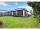 Serene backyard featuring a screened-in porch, providing a relaxing outdoor living space at 1015 143Rd Ne St, Bradenton, FL 34212