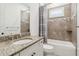 Well-lit bathroom featuring a granite vanity top, tub with tile surround, and a coordinated shower curtain at 1015 143Rd Ne St, Bradenton, FL 34212