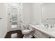 Bright powder room featuring a pedestal sink and a door leading to the backyard at 1015 143Rd Ne St, Bradenton, FL 34212