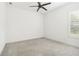 Well-lit bedroom with neutral carpet, and a ceiling fan, enhanced by a window with shutter style blinds at 1015 143Rd Ne St, Bradenton, FL 34212