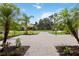 Long brick-paved driveway leads to the house, beautifully landscaped with palm trees at 1015 143Rd Ne St, Bradenton, FL 34212