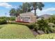 Beautiful entrance sign for Winding River community with lush landscaping and vibrant flowers at 1015 143Rd Ne St, Bradenton, FL 34212