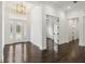 Bright foyer with elegant glass-paneled double doors and dark hardwood floors at 1015 143Rd Ne St, Bradenton, FL 34212