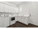 Efficient laundry room with ample white cabinetry, modern washer and dryer, and dark, attractive wood-look flooring at 1015 143Rd Ne St, Bradenton, FL 34212