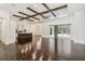 Open-concept living area with access to an outdoor pool, highlighted by dark hardwood floors at 1015 143Rd Ne St, Bradenton, FL 34212