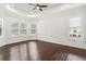 Spacious main bedroom with plantation shutters, tray ceilings, and hardwood floors at 1015 143Rd Ne St, Bradenton, FL 34212