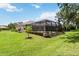 Screened in swimming pool and outdoor space with meticulously maintained landscaping and lawn at 1015 143Rd Ne St, Bradenton, FL 34212