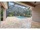 Screened swimming pool and patio area with a tiled floor at 1015 143Rd Ne St, Bradenton, FL 34212
