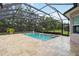 Screened swimming pool featuring clear blue water and beige tile surround at 1015 143Rd Ne St, Bradenton, FL 34212