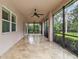 Covered porch with tiled floor, ceiling fans and views of the green yard at 1015 143Rd Ne St, Bradenton, FL 34212