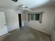 This bedroom includes a ceiling fan, a window, and carpet flooring at 1036 Arden Nw Ter, Port Charlotte, FL 33948