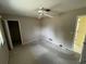 A carpeted bedroom with neutral walls, a ceiling fan, and two doors at 1036 Arden Nw Ter, Port Charlotte, FL 33948