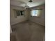 A carpeted bedroom with two windows, curtains, and neutral walls at 1036 Arden Nw Ter, Port Charlotte, FL 33948