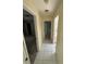 Hallway with tile flooring, leading to a bedroom and a bathroom at 1036 Arden Nw Ter, Port Charlotte, FL 33948