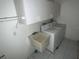 Laundry room features a utility sink, washer, dryer, and cabinets at 1036 Arden Nw Ter, Port Charlotte, FL 33948