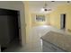 Bright living room with ceiling fan, leading to a kitchen at 1036 Arden Nw Ter, Port Charlotte, FL 33948