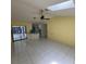 Bright living room features tile floors, fan, and skylight at 1036 Arden Nw Ter, Port Charlotte, FL 33948