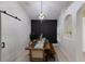 This dining room features a rustic table, modern chandelier, shiplap accent wall, and bright white walls at 12015 Forest Park Cir, Bradenton, FL 34211