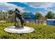 A statue in the dog park features a hugging a dog, within a fenced area, landscaping, and shaded areas at 12015 Forest Park Cir, Bradenton, FL 34211