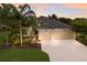 Attractive home featuring a well-maintained lawn, mature landscaping, and a spacious two-car garage at 12015 Forest Park Cir, Bradenton, FL 34211