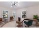 Bright home office with modern lighting, light walls, and stylish wooden desk and chairs at 12015 Forest Park Cir, Bradenton, FL 34211