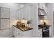 This is a modern kitchen featuring white cabinets, granite countertops, and stainless steel appliances at 12015 Forest Park Cir, Bradenton, FL 34211