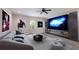 Comfortable living room featuring a sofa, a large screen television, and modern decor at 12015 Forest Park Cir, Bradenton, FL 34211