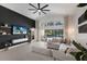 Bright living room with a black accent wall, modern fan, access to pool and backyard at 12015 Forest Park Cir, Bradenton, FL 34211