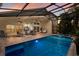 Screened-in pool with a patio, seating area, and jacuzzi at sunset at 12015 Forest Park Cir, Bradenton, FL 34211
