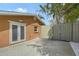 Backyard featuring a concrete patio and metal gate at 1203 Lyric Ln, Sarasota, FL 34242