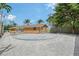 Backyard with a circular patio, rock landscaping and lush tropical foliage at 1203 Lyric Ln, Sarasota, FL 34242