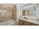 This is a bathroom featuring modern sink vanity, led mirror, and tiled bathtub and shower at 1203 Lyric Ln, Sarasota, FL 34242