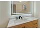 Bathroom features a modern sink, marble countertop and a light-up mirror at 1203 Lyric Ln, Sarasota, FL 34242