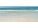 Serene beach scene with gentle waves meeting the sandy shore at 1203 Lyric Ln, Sarasota, FL 34242