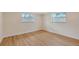 Bright bedroom with wood floors, white trim, and two windows at 1203 Lyric Ln, Sarasota, FL 34242