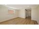 This is a bright bedroom with laminate flooring, neutral paint, and sliding closet doors at 1203 Lyric Ln, Sarasota, FL 34242