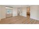 Bedroom featuring wood floors, closet with mirrored doors, and access to the bathroom and hallway at 1203 Lyric Ln, Sarasota, FL 34242