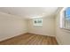 This is a bedroom featuring new laminate flooring, recessed lighting, and a window at 1203 Lyric Ln, Sarasota, FL 34242