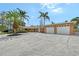 Stunning home featuring an oversized driveway, lush landscaping, and an attached two-car garage at 1203 Lyric Ln, Sarasota, FL 34242