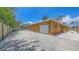 This is a detached garage with a large driveway and yard at 1203 Lyric Ln, Sarasota, FL 34242