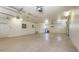 Large three-car garage with a sealed concrete floor, wash basin and an additional service door at 1203 Lyric Ln, Sarasota, FL 34242