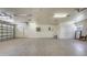 Spacious three-car garage with a sealed concrete floor, wash basin and an additional service door at 1203 Lyric Ln, Sarasota, FL 34242